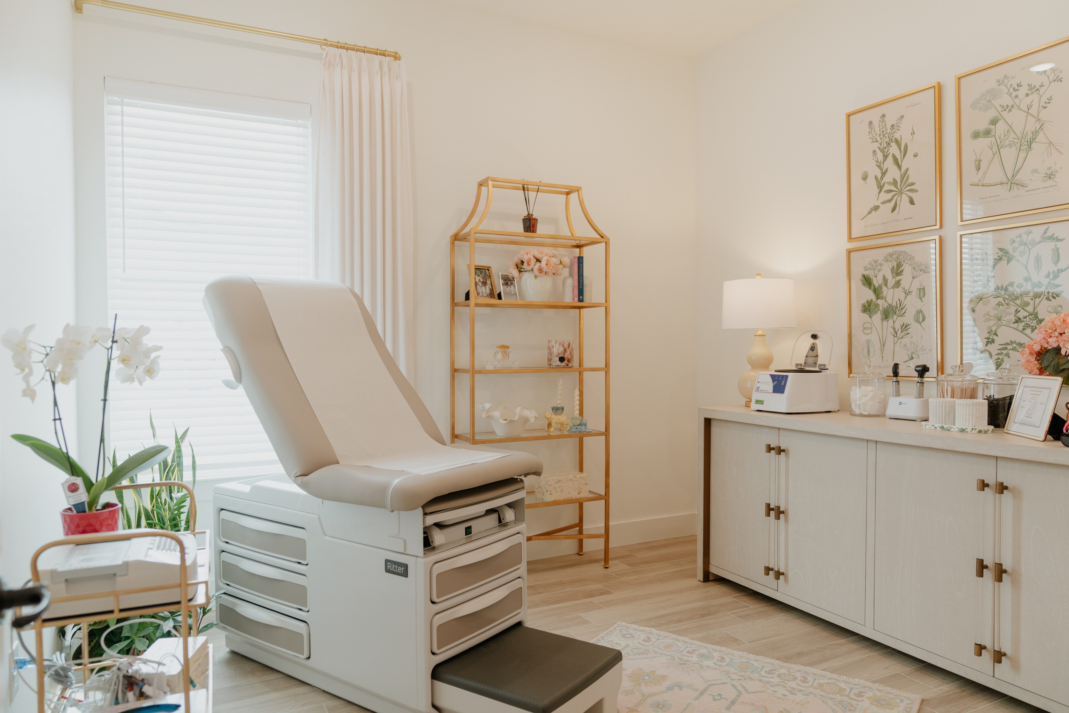 An OmriMed exam room, styled with botanical prints